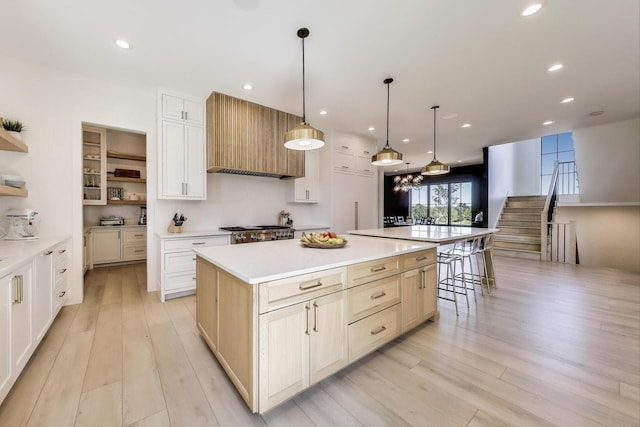 16226 Syd Creek Dr, Homer Glen, IL 60491 - kitchen with open shelves, wall chimney exhaust hood, light wood-type flooring, a large island, and light countertops