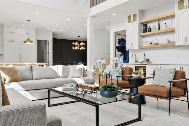 16226 Syd Creek Dr, Homer Glen, IL 60491 - living area featuring wine cooler, recessed lighting, a chandelier, light wood-style floors, and a towering ceiling