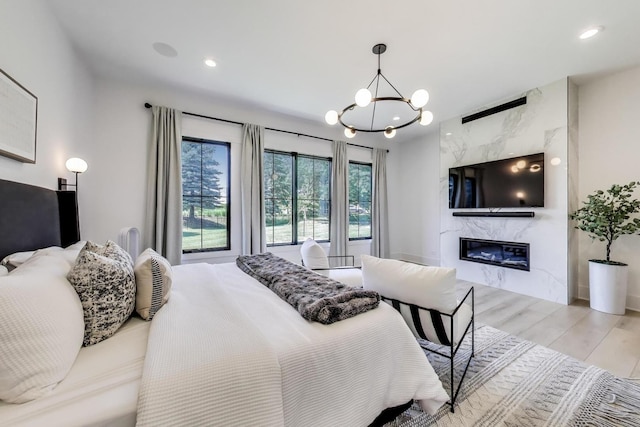 16226 Syd Creek Dr, Homer Glen, IL 60491 - bedroom with a high end fireplace, a chandelier, light wood-style flooring, and recessed lighting