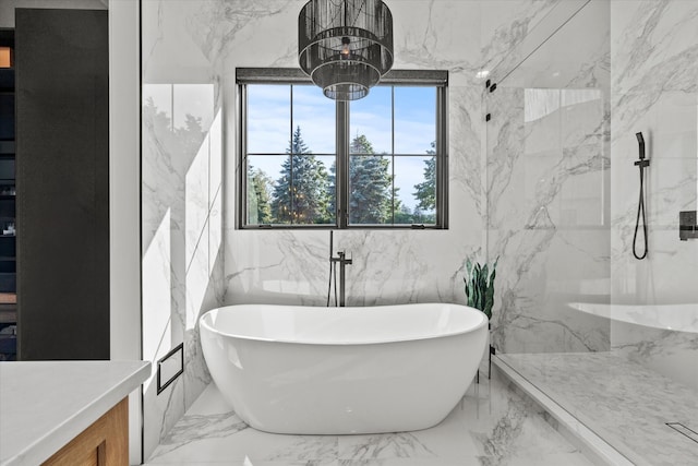16226 Syd Creek Dr, Homer Glen, IL 60491 - bathroom featuring a freestanding bath, marble tiled floors, a marble finish shower, and stone wall