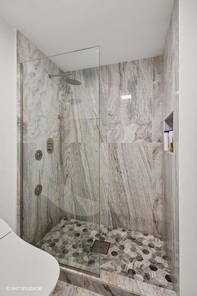 4050 Dundee Rd Unit 209, Northbrook, IL 60062 - bathroom featuring toilet and a marble finish shower