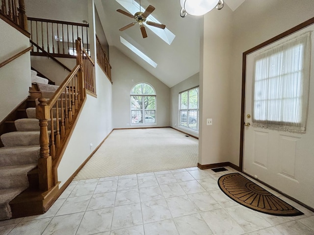 4797 Amber Cir, Hoffman Estates, IL 60192 - carpeted entrance foyer with ceiling fan, stairway, a skylight, marble look tile flooring, and high vaulted ceiling