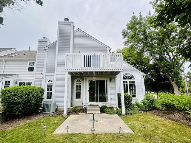4797 Amber Cir, Hoffman Estates, IL 60192 - back of house featuring a lawn, a chimney, a patio area, and a balcony