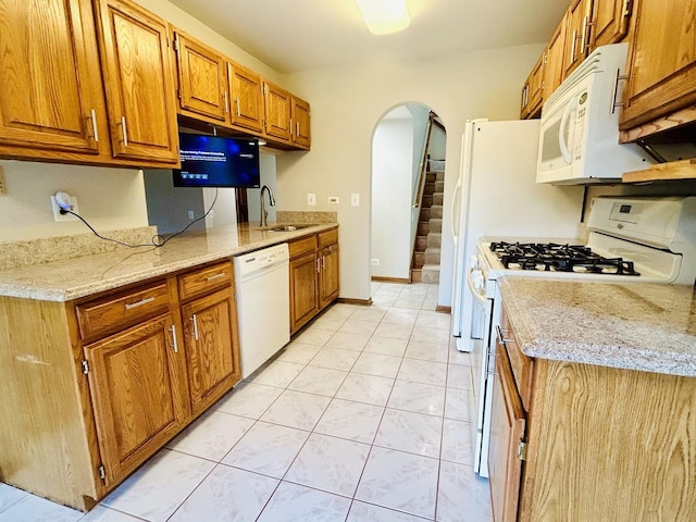 4797 Amber Cir, Hoffman Estates, IL 60192 - kitchen with white appliances, arched walkways, brown cabinets, light stone countertops, and light marble finish flooring