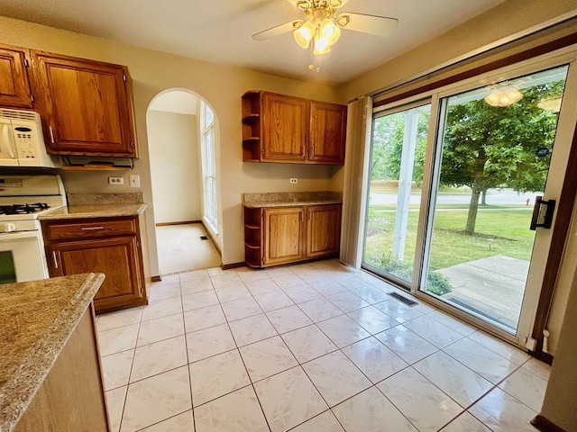 4797 Amber Cir, Hoffman Estates, IL 60192 - kitchen with white appliances, arched walkways, open shelves, brown cabinets, and ceiling fan