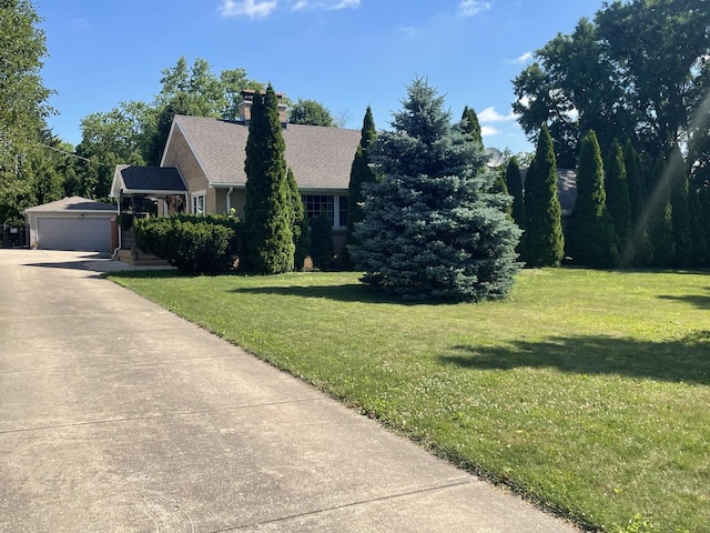1005 Black Rd, Joliet, IL 60435 - view of front of house featuring a front yard, a chimney, and an outbuilding