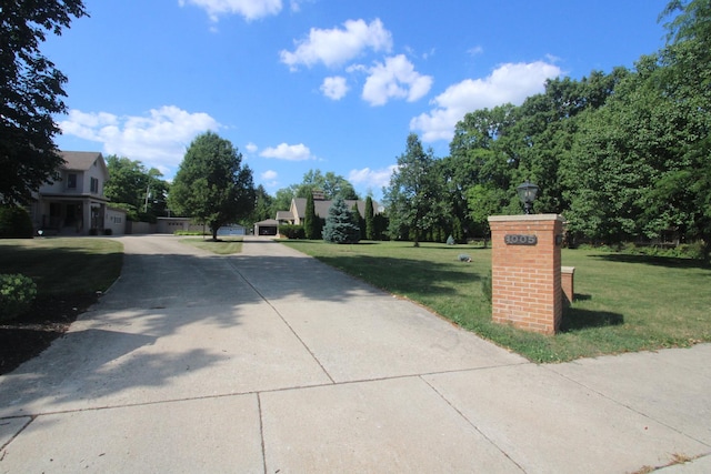 1005 Black Rd, Joliet, IL 60435 - view of concrete driveway with street lighting