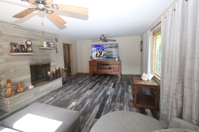 1005 Black Rd, Joliet, IL 60435 - living area featuring wood finished floors, a stone fireplace, and ceiling fan