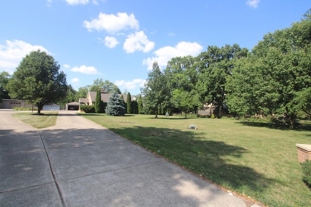 1005 Black Rd, Joliet, IL 60435 - view of grassy yard with a garage and concrete driveway
