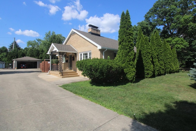 1005 Black Rd, Joliet, IL 60435 - view of front facade featuring a front yard, a chimney, a garage, an outdoor structure, and roof with shingles