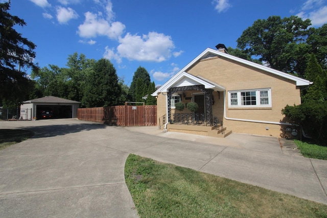 1005 Black Rd, Joliet, IL 60435 - view of front of property featuring brick siding, an outbuilding, a chimney, and a garage