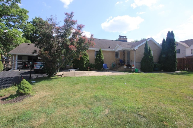 1005 Black Rd, Joliet, IL 60435 - back of property with brick siding, a chimney, a patio area, and a carport