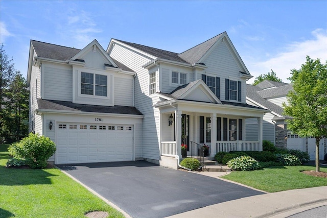 1781 Aberdeen Dr, Glenview, IL 60025 - view of front of home with a porch, asphalt driveway, a garage, and a front yard