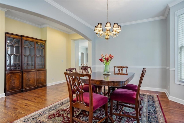 1781 Aberdeen Dr, Glenview, IL 60025 - dining area featuring arched walkways, wood finished floors, a chandelier, and crown molding