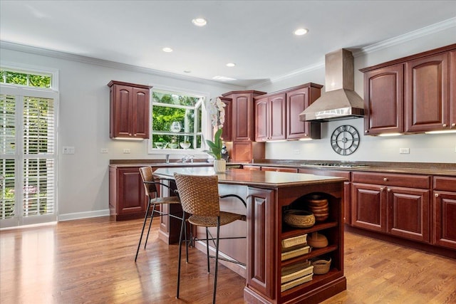 1781 Aberdeen Dr, Glenview, IL 60025 - kitchen featuring wall chimney range hood, a center island, plenty of natural light, dark countertops, and crown molding