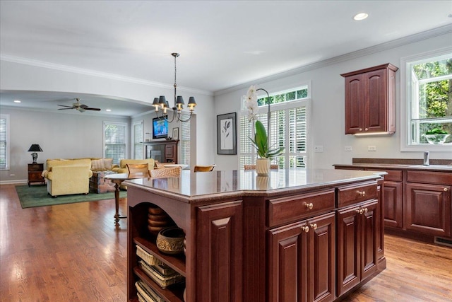 1781 Aberdeen Dr, Glenview, IL 60025 - kitchen featuring plenty of natural light, a chandelier, light wood-type flooring, a center island, and ornamental molding
