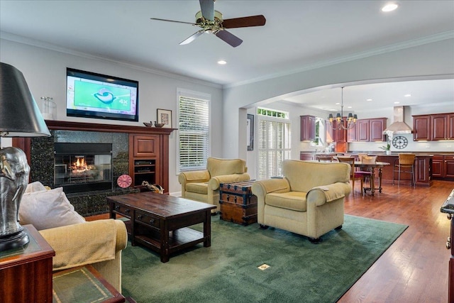 1781 Aberdeen Dr, Glenview, IL 60025 - living room featuring a ceiling fan, arched walkways, a chandelier, wood finished floors, and a high end fireplace