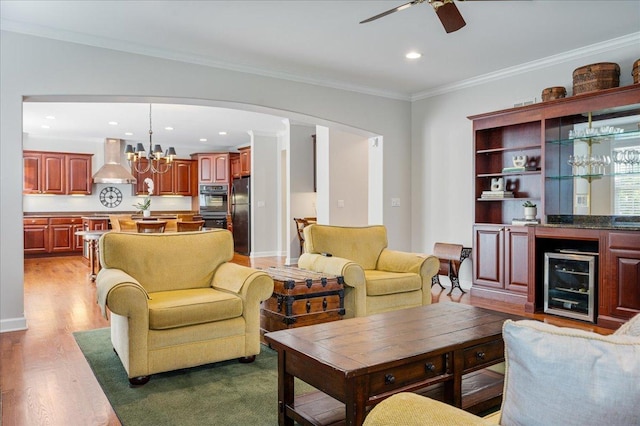 1781 Aberdeen Dr, Glenview, IL 60025 - living area with beverage cooler, a ceiling fan, wood finished floors, arched walkways, and ornamental molding
