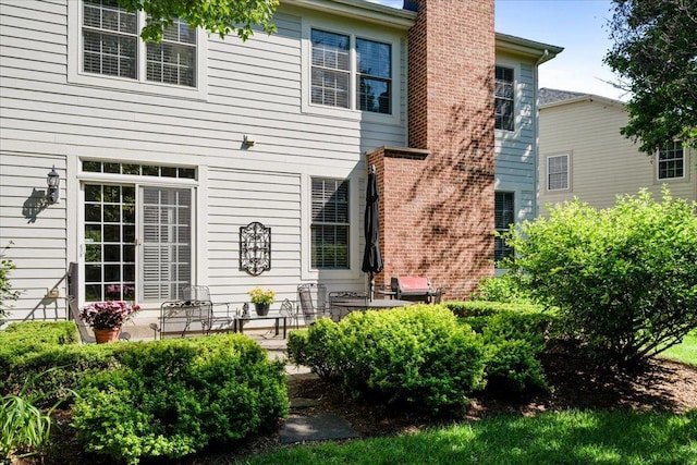1781 Aberdeen Dr, Glenview, IL 60025 - rear view of house with a chimney