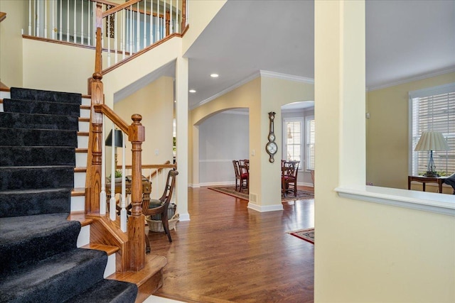 1781 Aberdeen Dr, Glenview, IL 60025 - foyer entrance with arched walkways, crown molding, wood finished floors, stairway, and recessed lighting