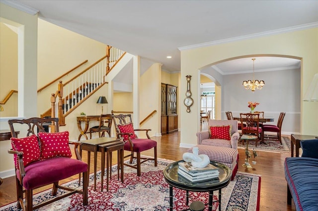 1781 Aberdeen Dr, Glenview, IL 60025 - living room featuring arched walkways, wood finished floors, crown molding, stairway, and a chandelier