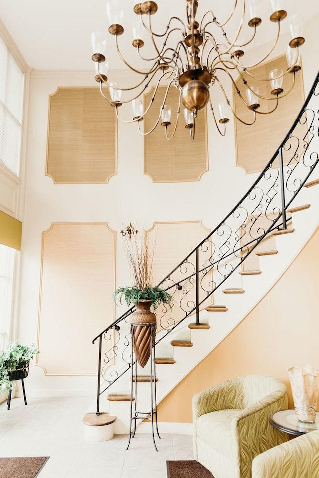 3427 Vollmer Rd Unit 209, Flossmoor, IL 60422 - stairway featuring a chandelier, a towering ceiling, and tile patterned flooring