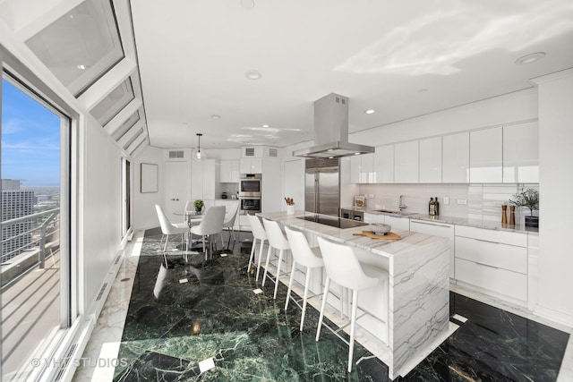 950 N Michigan Ave Unit 4904, Chicago, IL 60611 - kitchen featuring island range hood, stainless steel appliances, modern cabinets, marble tiled flooring, and recessed lighting
