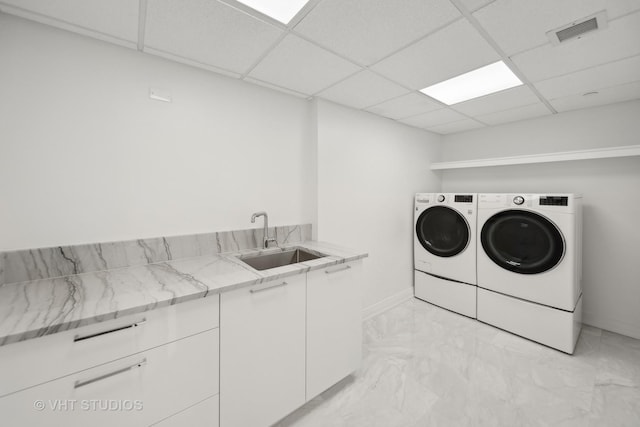 950 N Michigan Ave Unit 4904, Chicago, IL 60611 - laundry area featuring washing machine and clothes dryer, cabinet space, and light marble finish flooring