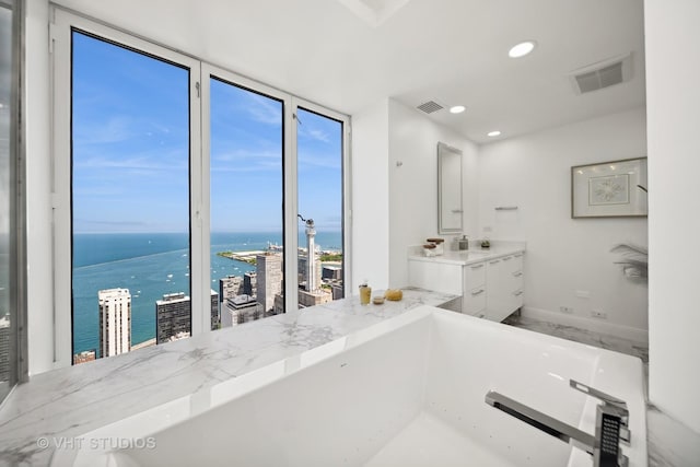 950 N Michigan Ave Unit 4904, Chicago, IL 60611 - bathroom featuring a water view, vanity, a bathtub, and recessed lighting