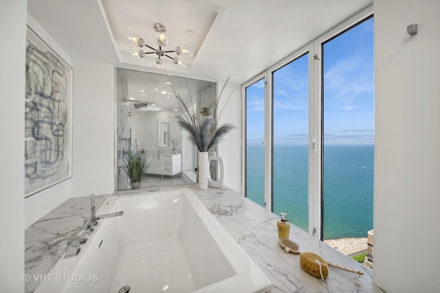 950 N Michigan Ave Unit 4904, Chicago, IL 60611 - full bathroom featuring a water view, a garden tub, a chandelier, and a marble finish shower