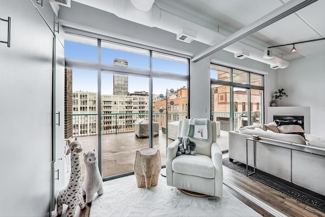 920 W Madison St Unit F8, Chicago, IL 60607 - living area with a city view, healthy amount of natural light, and track lighting