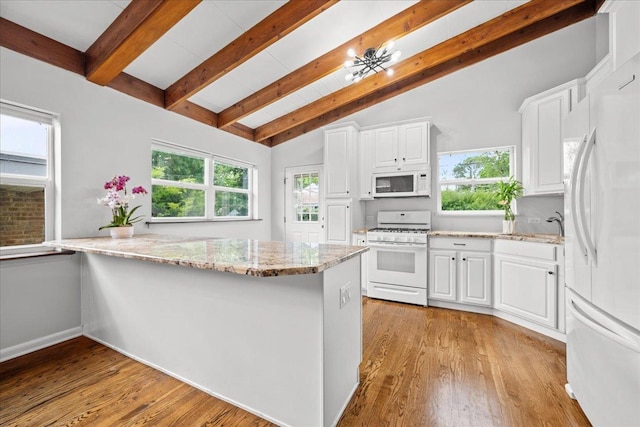 8844 Laramie Ave, Skokie, IL 60077 - kitchen featuring white appliances, white cabinetry, light stone countertops, and light wood-style floors