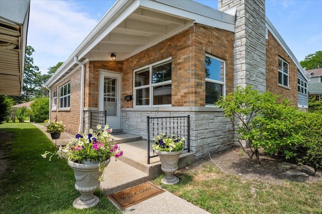 8844 Laramie Ave, Skokie, IL 60077 - view of front of property with stone siding, a chimney, brick siding, and a front yard