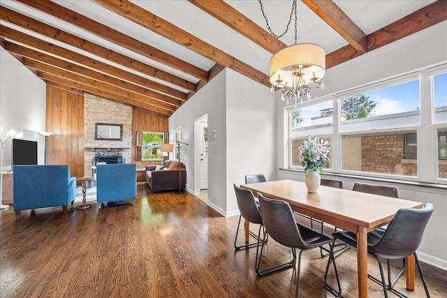 8844 Laramie Ave, Skokie, IL 60077 - dining room featuring beamed ceiling, wood finished floors, a chandelier, a fireplace, and high vaulted ceiling