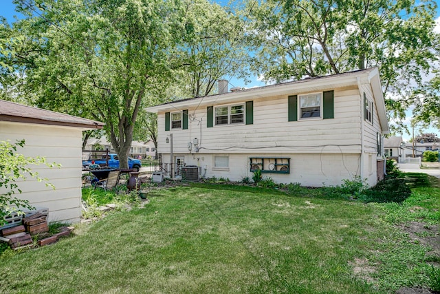 521 Michael Ave, Crete, IL 60417 - rear view of house featuring a chimney and a lawn