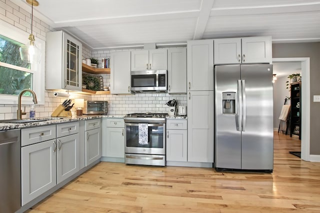 40474 N Glendale Ave, Beach Park, IL 60099 - kitchen with appliances with stainless steel finishes, beamed ceiling, tasteful backsplash, light wood finished floors, and light stone countertops
