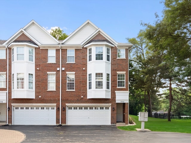 775 N Regis Ct, Palatine, IL 60067 - townhome / multi-family property featuring asphalt driveway, brick siding, and an attached garage