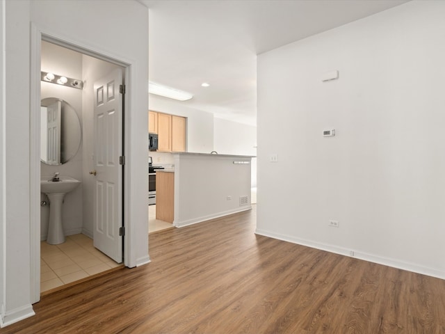 775 N Regis Ct, Palatine, IL 60067 - empty room with light wood finished floors and a sink