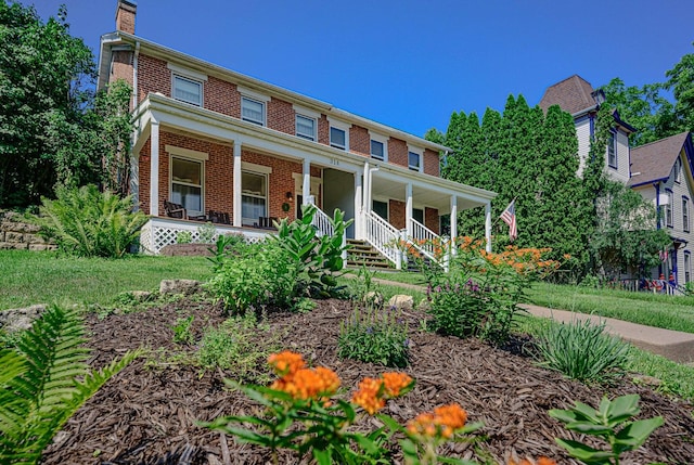 314 Elk St, Galena, IL 61036 - view of front of house featuring brick siding, covered porch, and a chimney