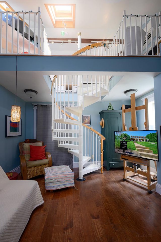 314 Elk St, Galena, IL 61036 - stairs featuring hardwood / wood-style flooring, a skylight, and a high ceiling