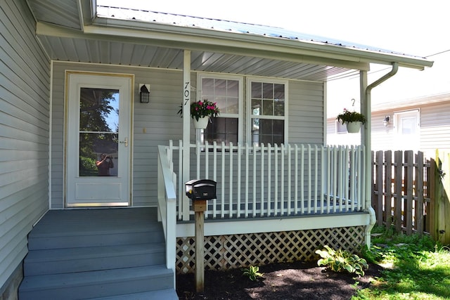 707 Omaha Ave, Lincoln, IL 62656 - doorway to property with a porch and a metal roof