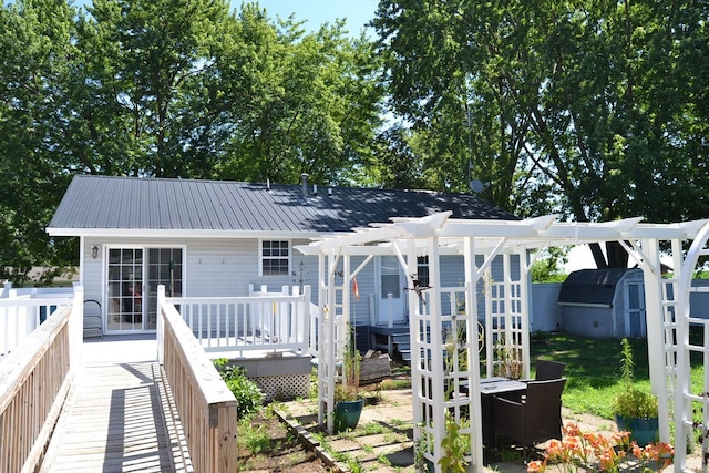 707 Omaha Ave, Lincoln, IL 62656 - back of house featuring a deck, a storage shed, a pergola, and a metal roof
