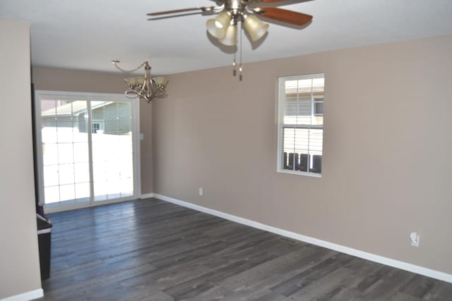 707 Omaha Ave, Lincoln, IL 62656 - spare room with a ceiling fan, plenty of natural light, a chandelier, and dark wood-type flooring