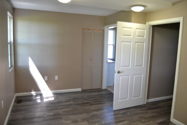707 Omaha Ave, Lincoln, IL 62656 - unfurnished bedroom with wood finished floors