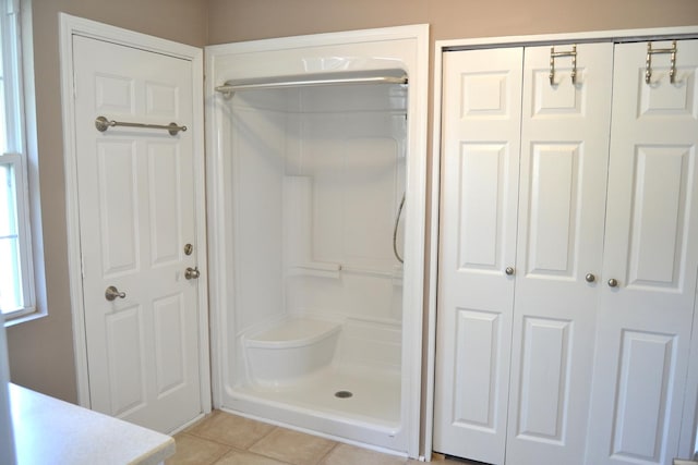 707 Omaha Ave, Lincoln, IL 62656 - bathroom featuring tile patterned flooring, a shower stall, a closet, and vanity