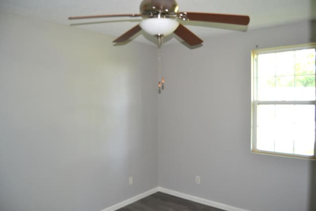 707 Omaha Ave, Lincoln, IL 62656 - unfurnished room with a ceiling fan and dark wood-style floors