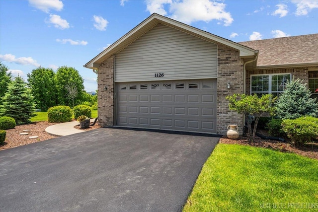 1126 Mandalay Ln Unit 1126, Bolingbrook, IL 60490 - view of front of house featuring brick siding, asphalt driveway, and a garage