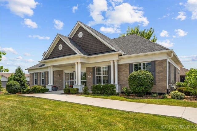 1126 Mandalay Ln Unit 1126, Bolingbrook, IL 60490 - craftsman house featuring brick siding, a front lawn, and a porch