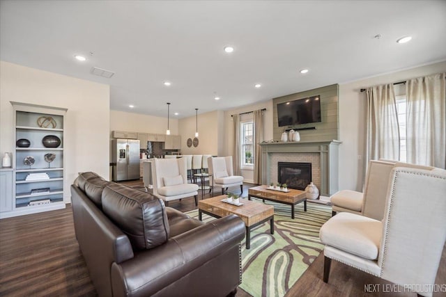 1126 Mandalay Ln Unit 1126, Bolingbrook, IL 60490 - living area featuring dark wood-type flooring, recessed lighting, and a brick fireplace