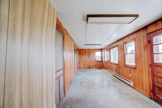 2371 N 3100 E Rd, Donovan, IL 60931 - unfurnished room featuring a baseboard heating unit, wood walls, track lighting, and concrete flooring